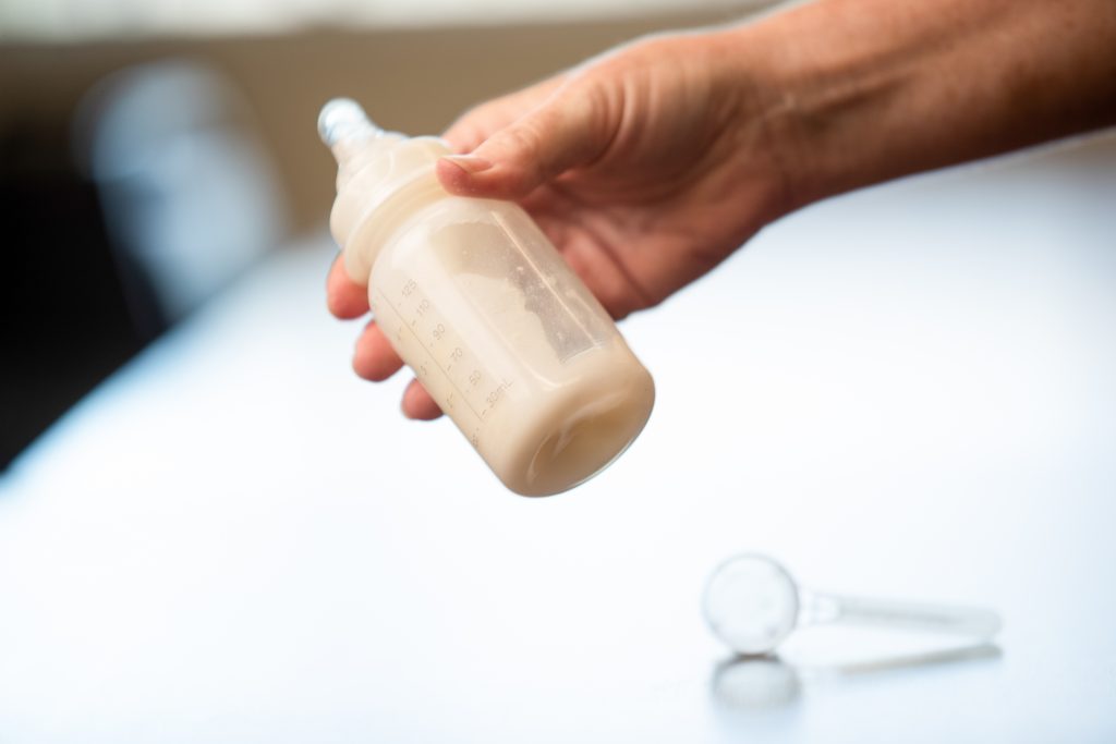 Person holding bottle with milk