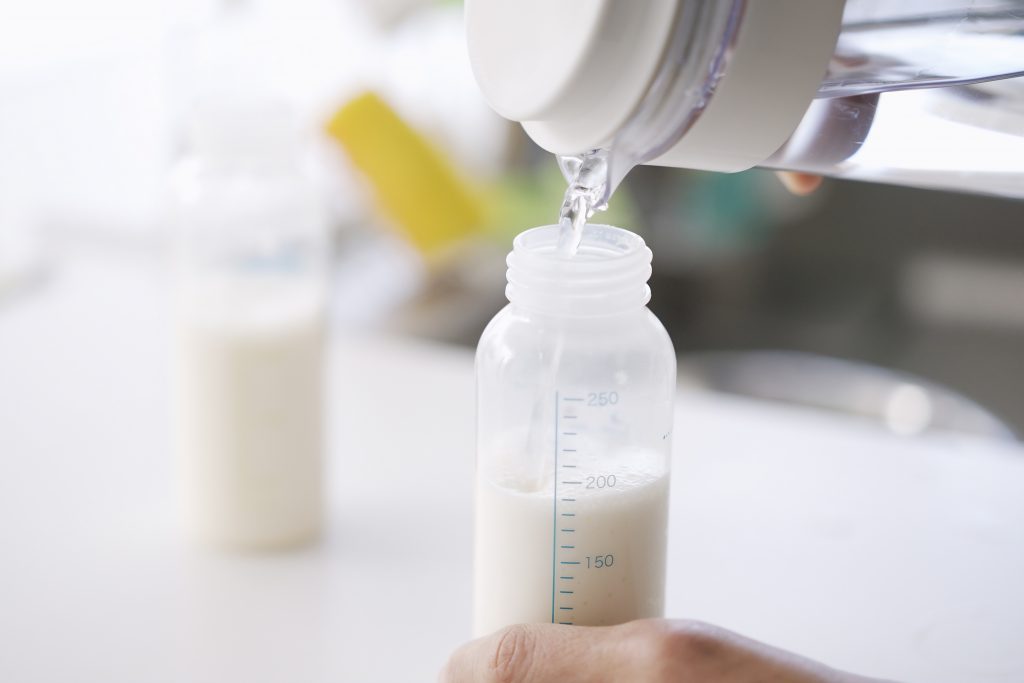 Featured Image of person making baby formula