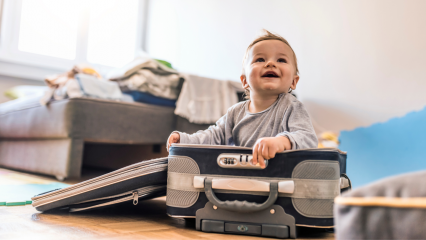 Baby travel concept. Photo of baby boy in travel suitcase