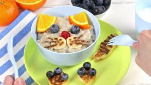 Healthy breakfast bowl with oatmeal and colorful fruit.